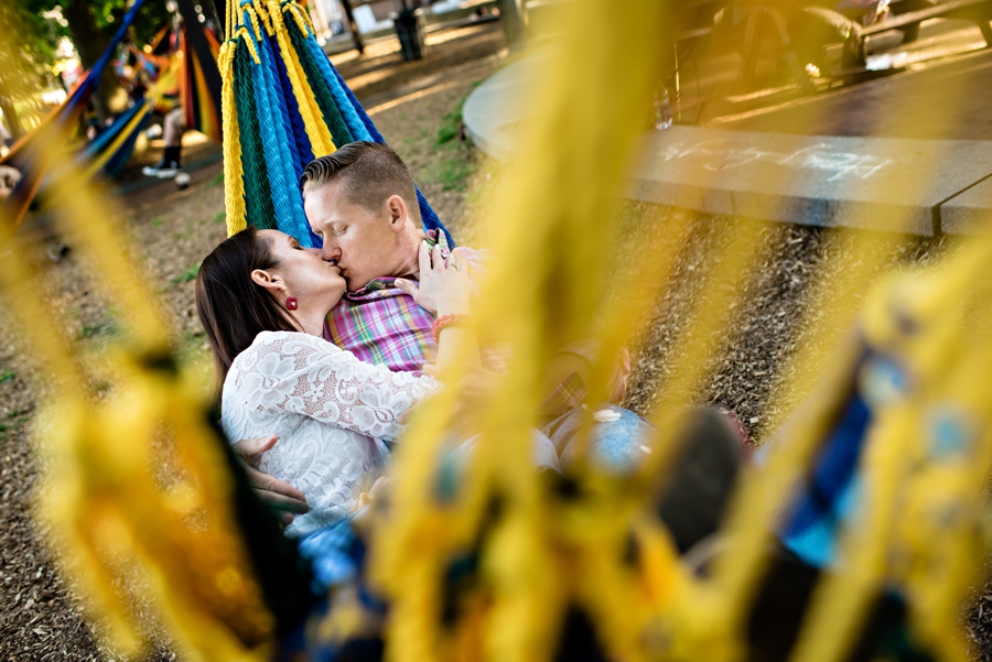 A man and woman cuddle in a hammok at Spruce Street Harbor Park in Philadephia for their engagement session.
